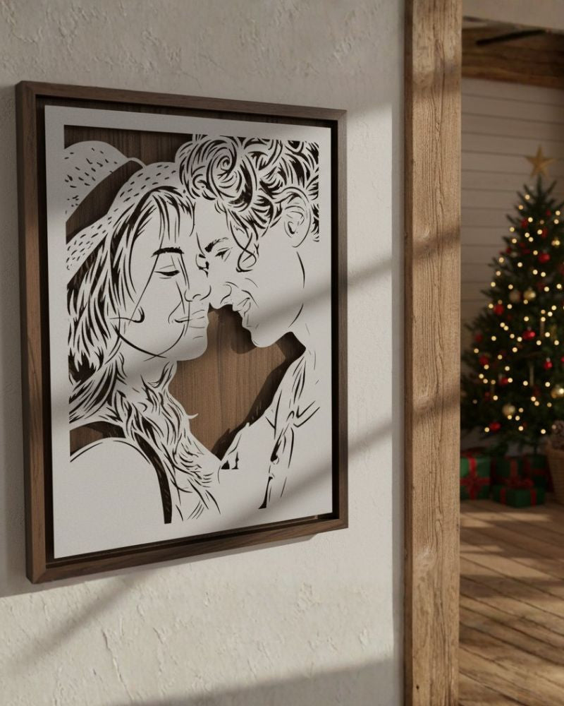 custom metal artwork of a couple kissing with a Christmas tree in the background