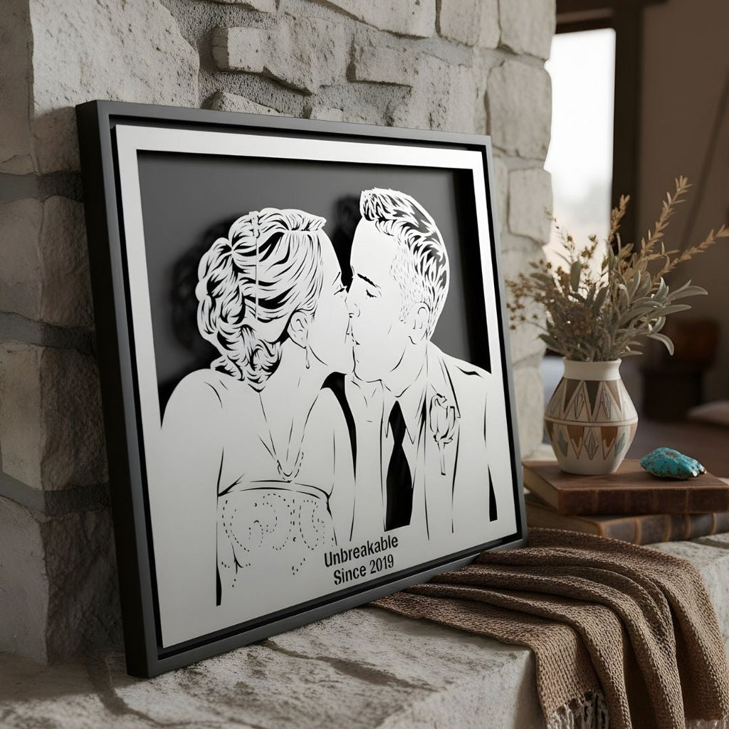 Wedding couple kissing, steel portrait in a black frame with their date cut below, on a stone mantel
