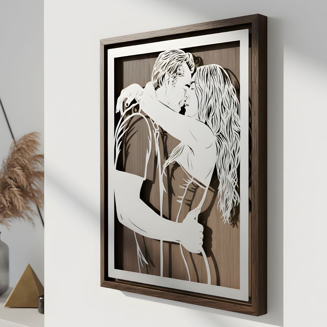Couple embracing, laser cut steel portrait in a walnut frame