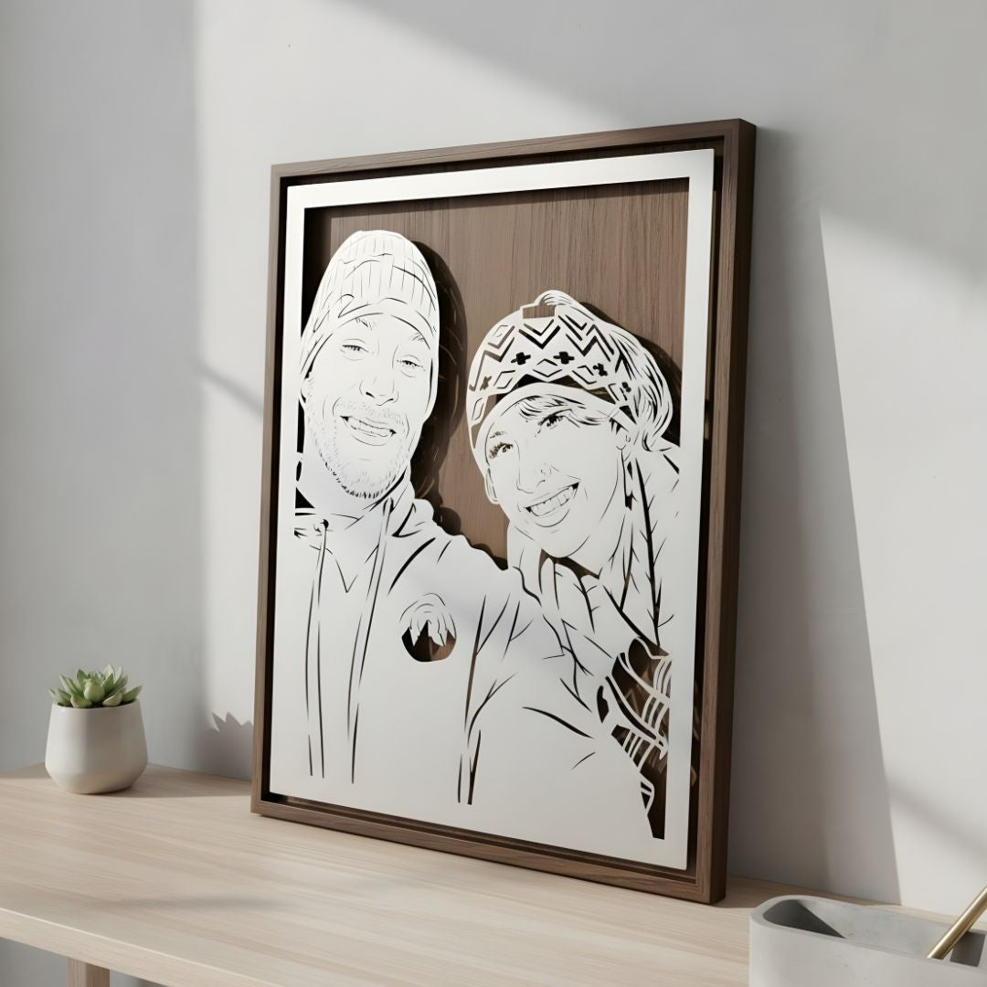 Couple in winter hats, laser cut steel portrait in a walnut frame