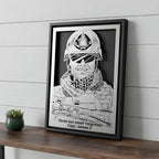 Memorial portrait of a soldier in helmet and gear, steel in a black frame with a tribute and his name cut below