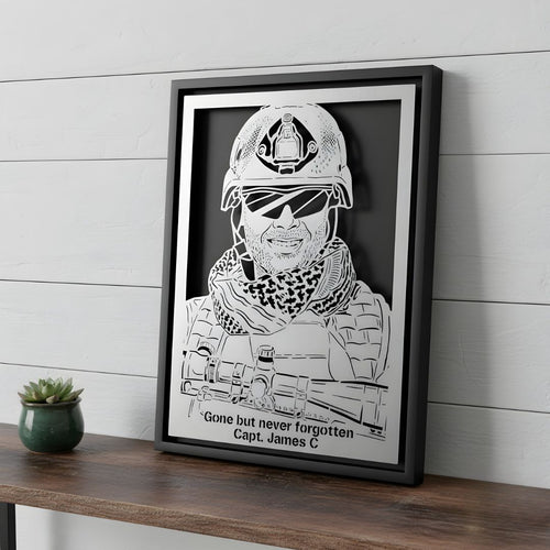Memorial portrait of a soldier in helmet and gear, steel in a black frame with a tribute and his name cut below