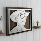 Memorial portrait of a man in a cowboy hat and glasses, landscape steel in a walnut frame with his name and years below