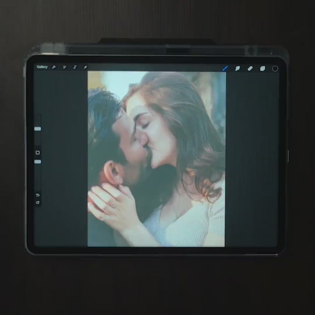 Video of an artist hand drawing a couple's kiss from their photo, the first step of a wedding anniversary metal portrait