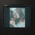 Video of an artist hand drawing a couple from their photo on a tablet, the first step of a custom metal portrait