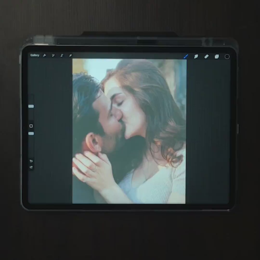 Video of an artist hand drawing a couple from their photo on a tablet, the first step of a custom metal portrait