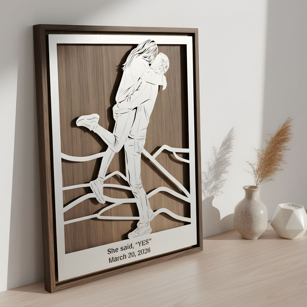 Couple embracing on a mountain trail with background art, walnut frame, the day she said yes cut below